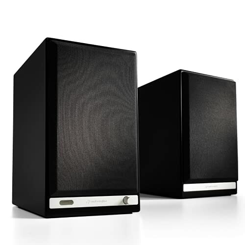 Pair of black wireless speakers with sleek design