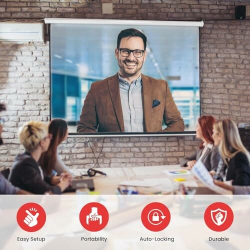 Team meeting with a presentation screen displaying a smiling man.