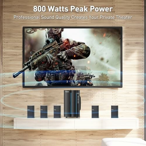 Home theater system with large screen displaying action scene, speakers below.