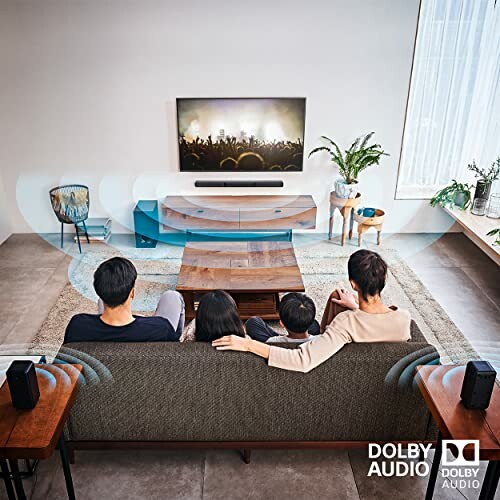 Family watching TV with Dolby Audio surround system in living room.