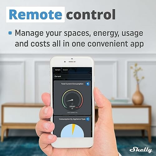 Hand holding phone with remote control app on screen.