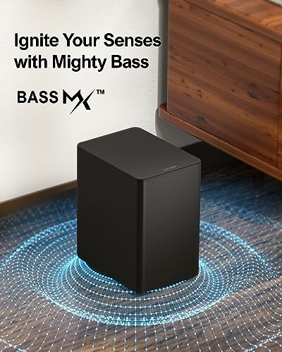 Black subwoofer with glowing bass effect next to furniture.
